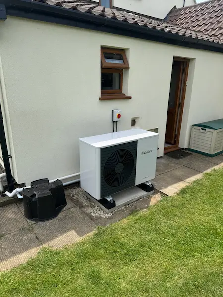 Heat pump that has replaced an oil boiler, heat pump is newly installed on a concrete base